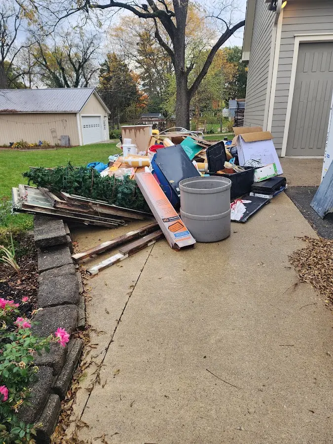 Dumpster being loaded with debris for 10 Yard Dumpster Rental in Prior Lake